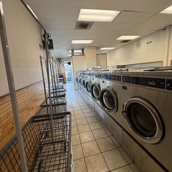 Laundry carts lined up by the washers