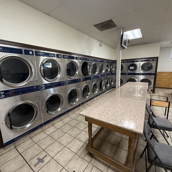 Stacked dryers and folding table